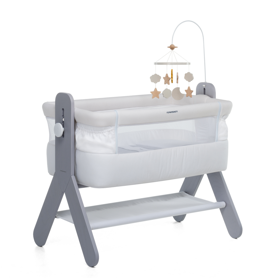 A bedside baby crib by Foppapedretti features a high-quality solid ash wood, designed and manufactured in Italy. The height can be adjusted to 5 positions to be adapted to any type of bed.