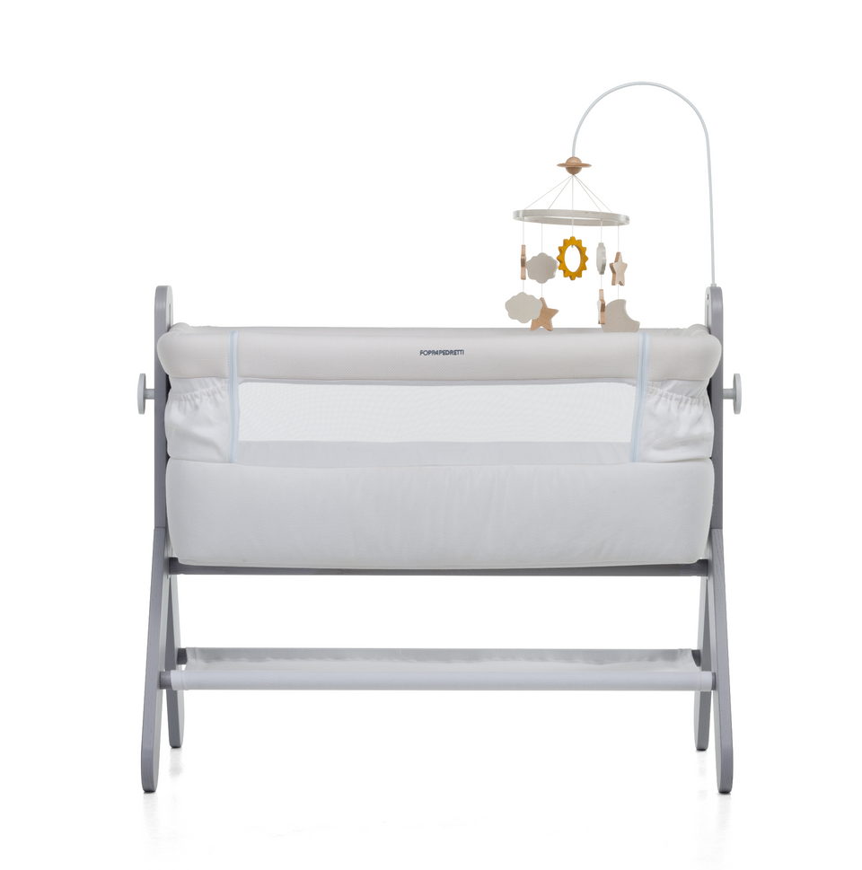 A bedside baby crib by Foppapedretti features a high-quality solid ash wood, designed and manufactured in Italy. The height can be adjusted to 5 positions to be adapted to any type of bed.