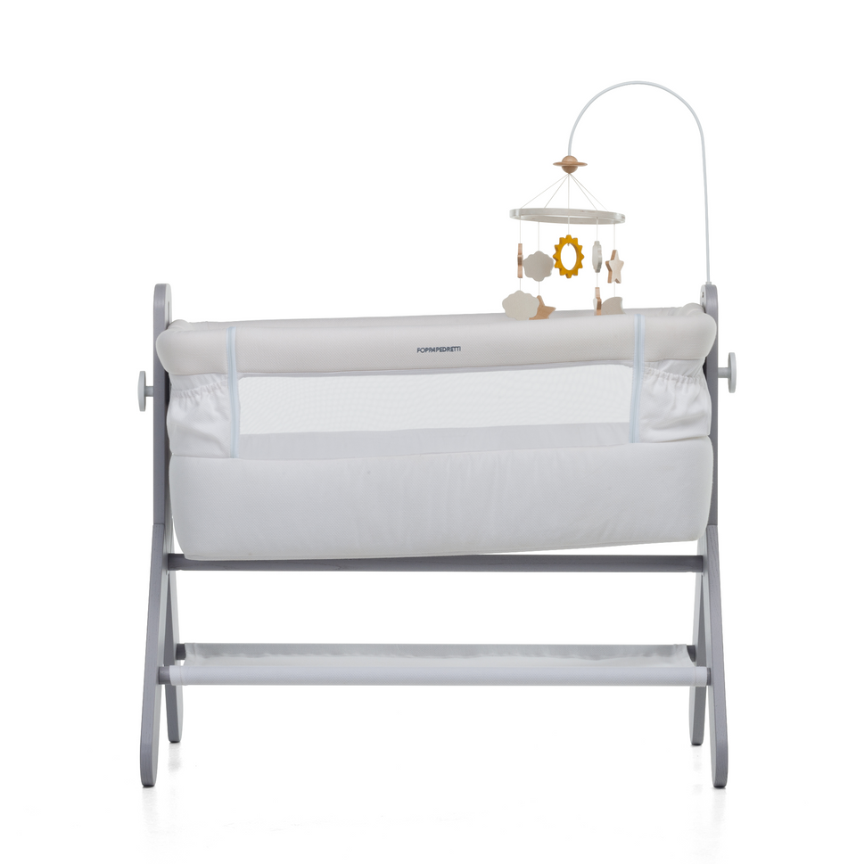 A bedside baby crib by Foppapedretti features a high-quality solid ash wood, designed and manufactured in Italy. The height can be adjusted to 5 positions to be adapted to any type of bed.