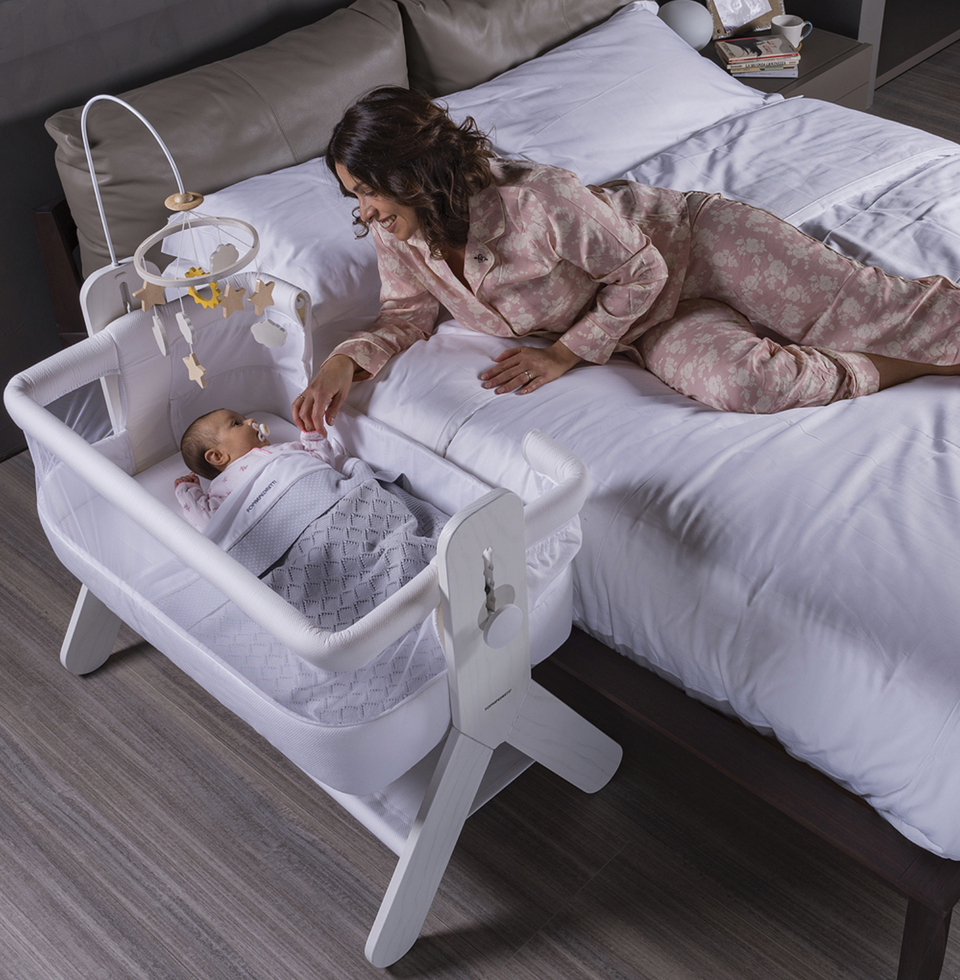 A bedside baby crib by Foppapedretti features a high-quality solid ash wood, designed and manufactured in Italy. The height can be adjusted to 5 positions to be adapted to any type of bed.