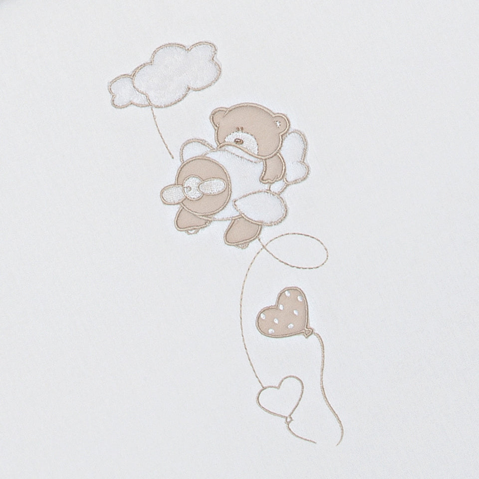 Closeup of the BabyFly duvet set for babycot featuring embroidery with a cute teddy bear flying on an aeroplane.